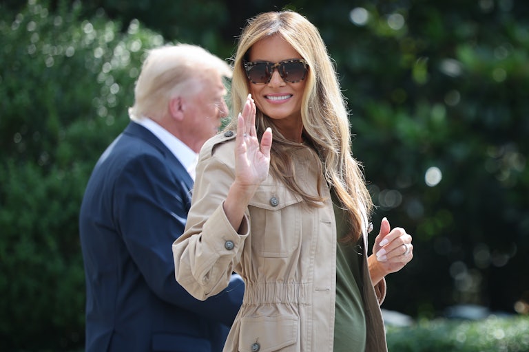 First Lady Melania Trump waves at reporters.