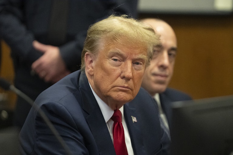Donald Trump sits in a courtroom looking bored or maybe falling asleep