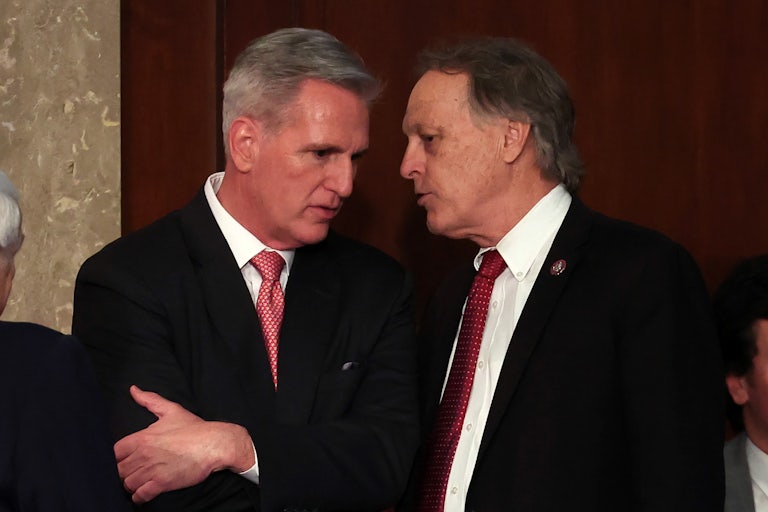 Kevin McCarthy speaks with Andy Biggs in the House chamber