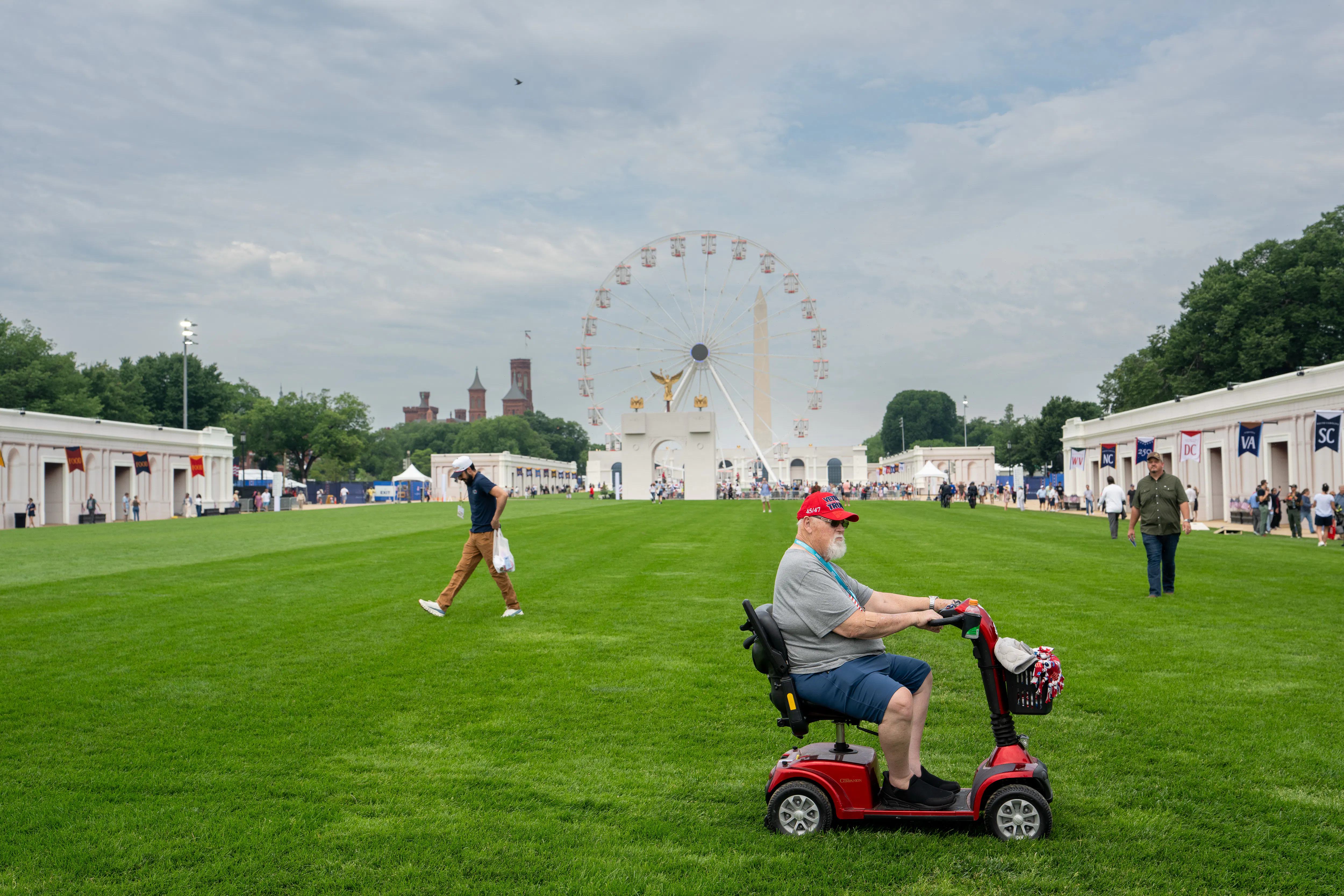An old man on a riding scooter visits the Great American State Fair, which is very sparsely attended. 