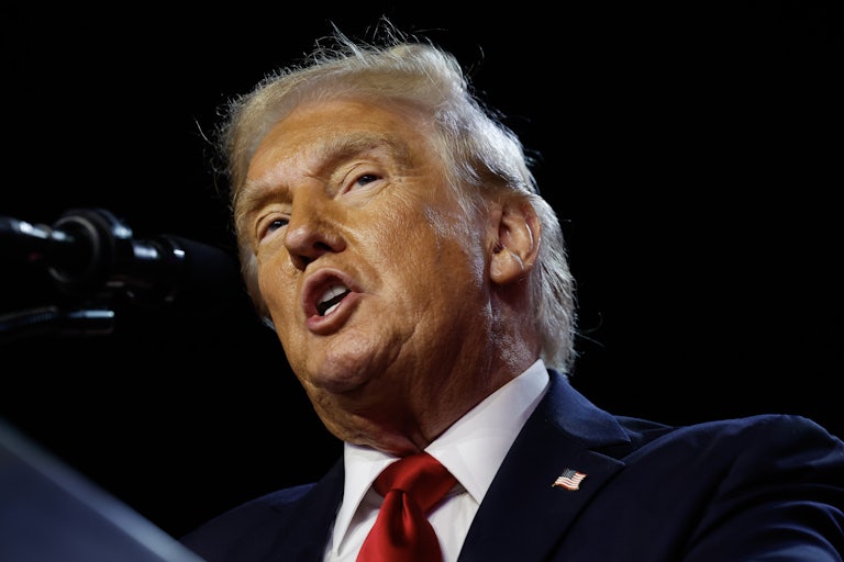 Donald Trump speaking at a mic