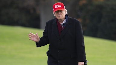 President Donald Trump walks on the White House lawn.