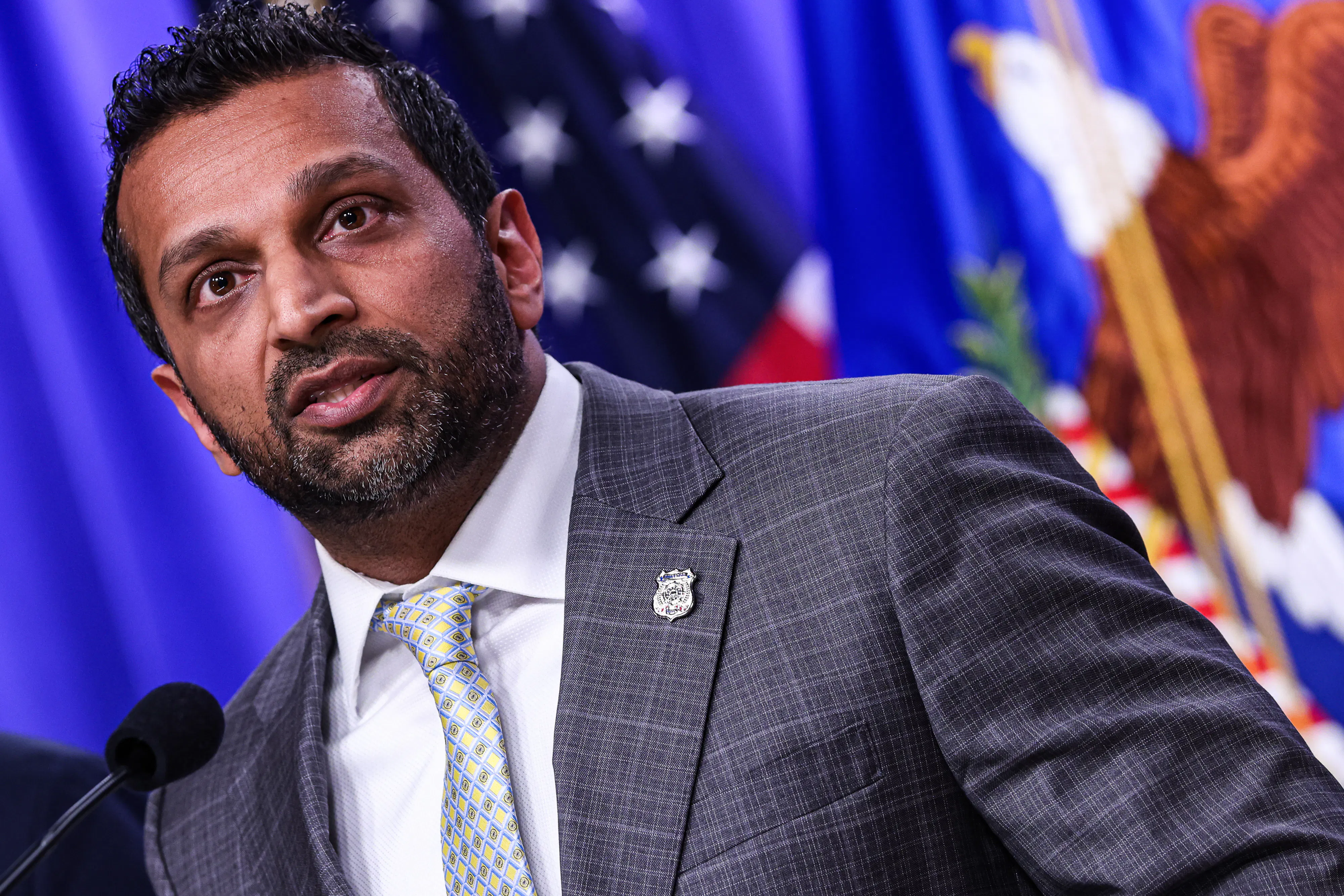 FBI Director Kash Patel speaks at a podium