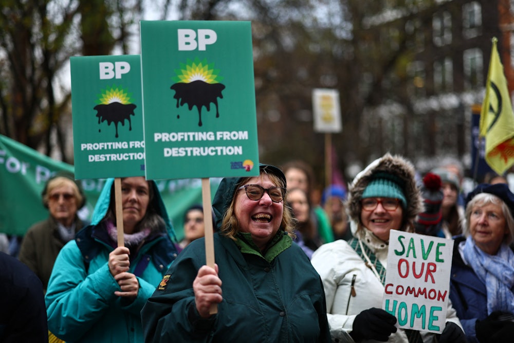 Demonstrators hold signs reading "BP: Profiting from Destruction."
