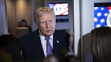 Donald Trump speaks to reporters aboard Air Force One.