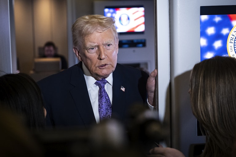 Donald Trump speaks to reporters aboard Air Force One.