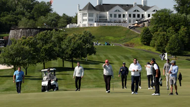 Donald Trump points while walking on the green at his golf club in Washington, D.C.