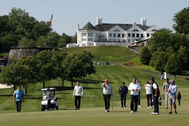 Donald Trump points while walking on the green at his golf club in Washington, D.C.