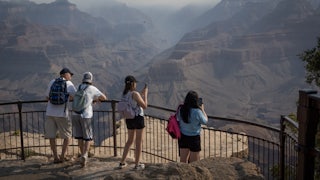On July 15, tourists took pictures of smoke from nearby wildfires settling into the Grand Canyon. The fires burned thousands of acres and destroyed the historic Grand Canyon Lodge.