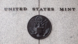 The U.S. Mint seal on the side of the building