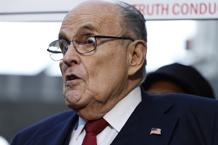 Rudy Giliani's eyes pop out of his head as he purses his lips.