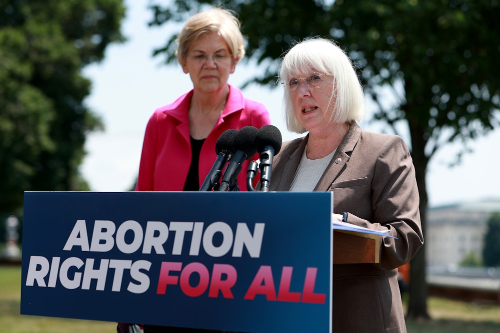 Senator Patty Murray talks to reporters outside the U.S. Capitol with fellow Democratic Senator Elizabeth Warren.