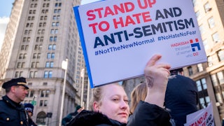 A protester holds up a sign against antisemitism at a rally in New York City's Foley Square.