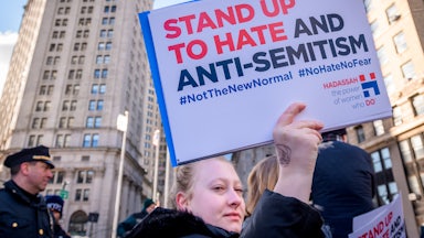 A protester holds up a sign against antisemitism at a rally in New York City's Foley Square.
