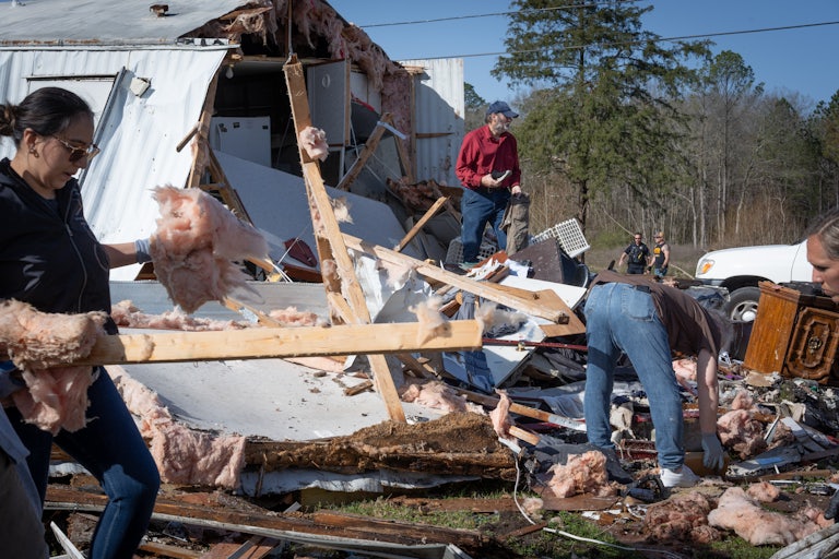 People go through the wreckage left by a tornado in Alabama