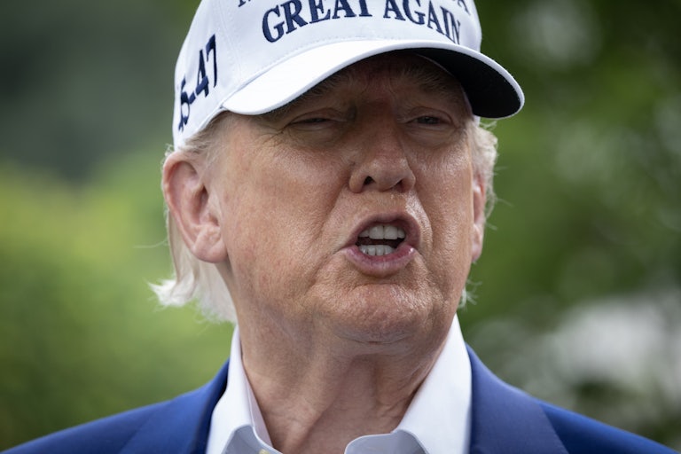 Donald Trump speaks while standing outside the White House