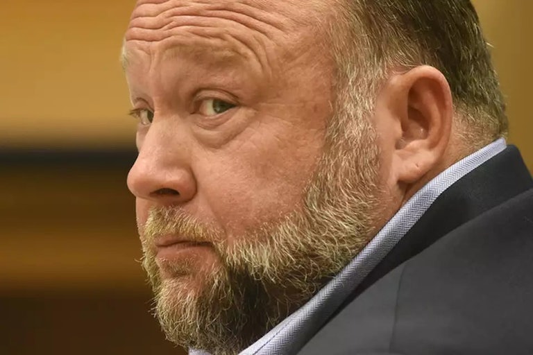 Alex Jones sits in a courtroom