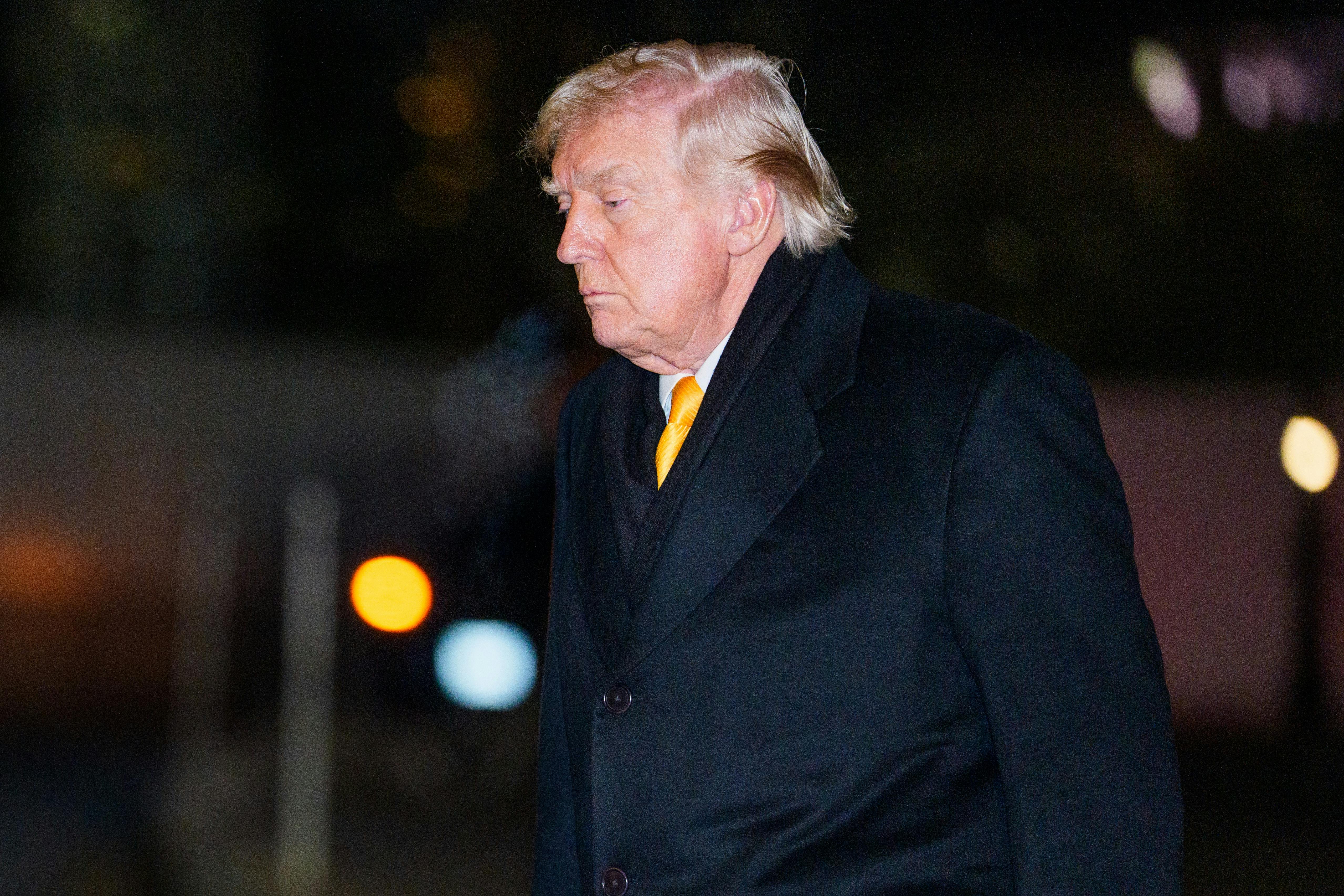 Donald Trump looks down as he walks