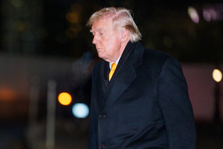 Donald Trump looks down as he walks