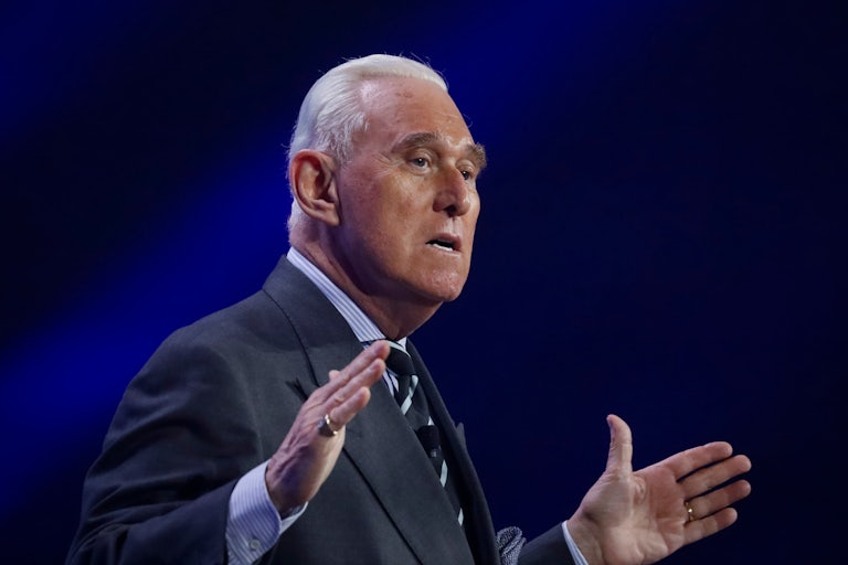 Roger Stone gestures while speaking
