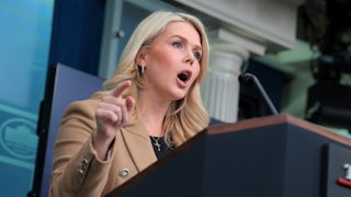 Karoline Leavitt yells at the podium in the White House press briefing room.