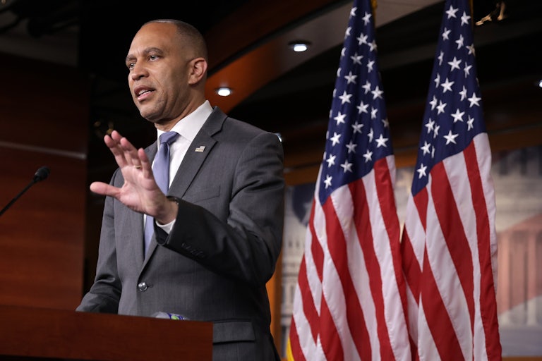 House Minority Leader Hakeem Jeffries gestures while speaking at a podium
