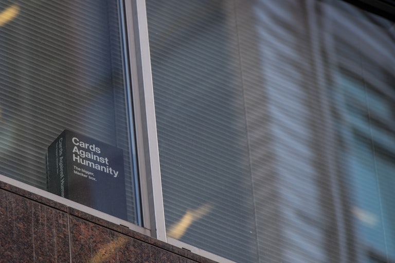 A large Cards Against Humanity box in the windowsill