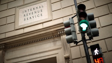 The front of the Internal Revenue Service building appears next to a green traffic light.