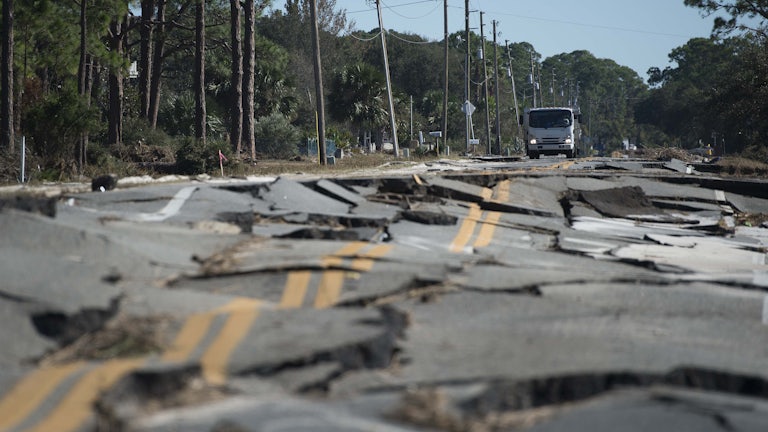 A truck stops at the top of a road destroyed during Hurricane Michael near Eastpoint, Florida 