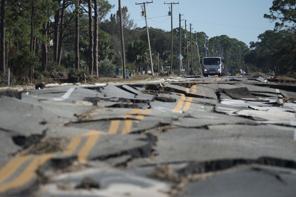 A truck stops at the top of a road destroyed during Hurricane Michael near Eastpoint, Florida