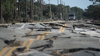 A truck stops at the top of a road destroyed during Hurricane Michael near Eastpoint, Florida