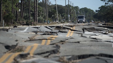 A truck stops at the top of a road destroyed during Hurricane Michael near Eastpoint, Florida