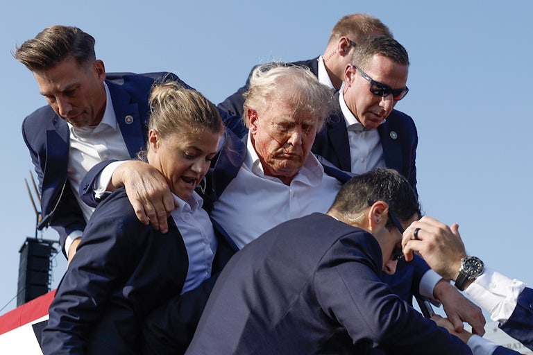 Secret Service members rush Donald Trump off stage at a rally in Butler, Pennsylvania, after an attempted assassination