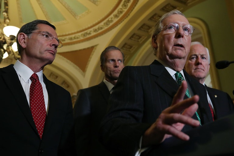 From left, John Barrasso, John Thune, and John Cornyn stand behind Mitch McConnell