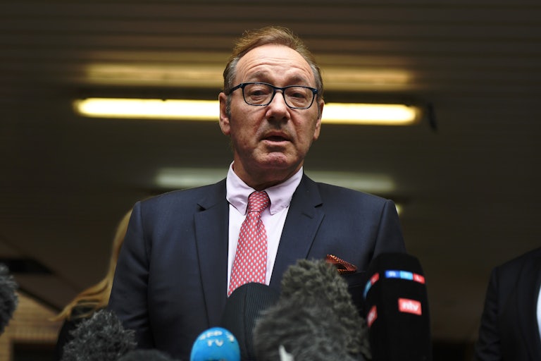 Kevin Spacey speaks into microphones