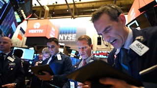 Traders work during the opening bell at the New York Stock Exchange.