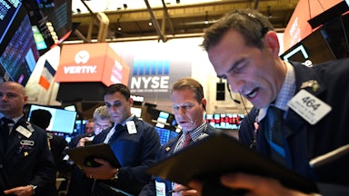 Traders work during the opening bell at the New York Stock Exchange.
