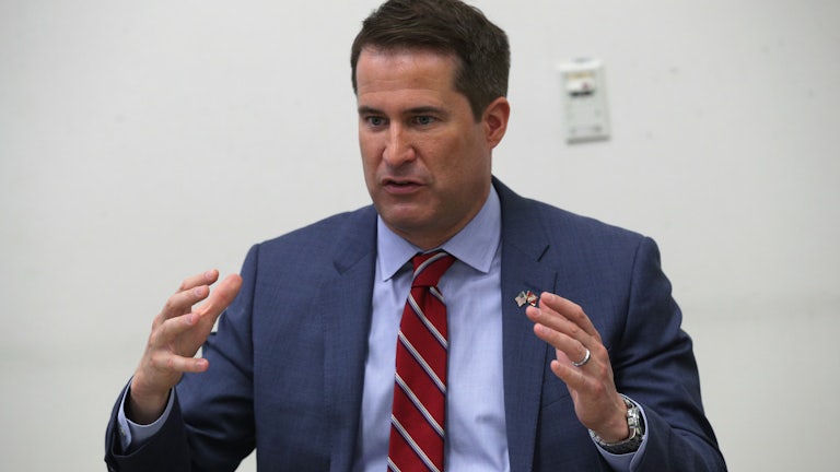 Representative Seth Moulton gestures as he speaks at a town hall in Virginia.