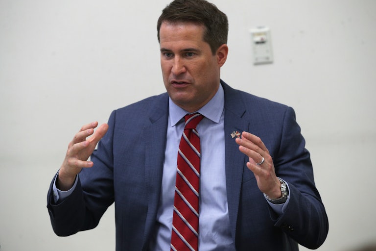 Representative Seth Moulton gestures as he speaks at a town hall in Virginia.