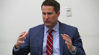 Representative Seth Moulton gestures as he speaks at a town hall in Virginia.
