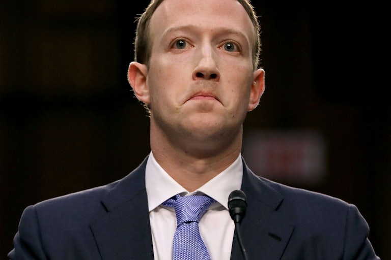 A close-up of Mark Zuckerberg, grimacing.
