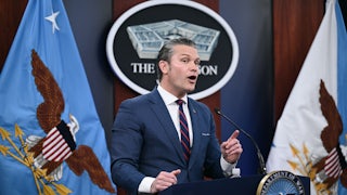 Defense Secretary Pete Hegseth gestures and speaks at a podium