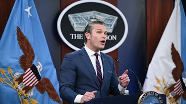 Defense Secretary Pete Hegseth gestures and speaks at a podium