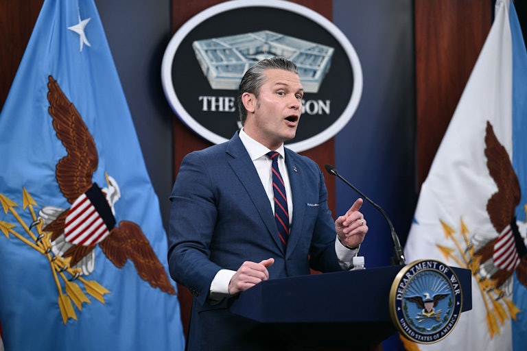 Defense Secretary Pete Hegseth gestures and speaks at a podium