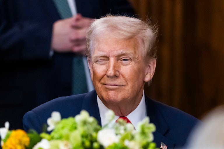Donald Trump winks while sitting in the Capitol