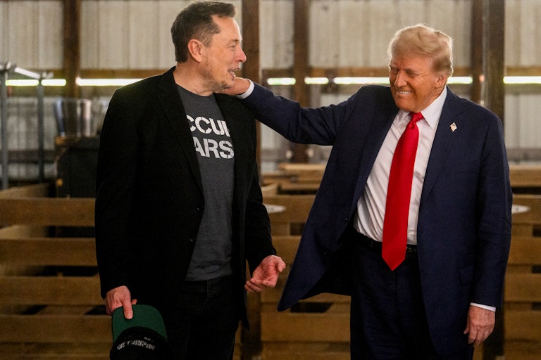 Donald Trump smiles and puts his hand on Elon Musk’s shoulder