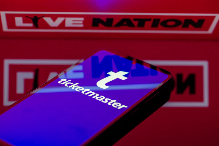 Phone with Ticketmaster in front of a Live Nation logo