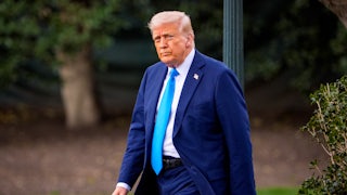 Donald Trump walks across the White House lawn
