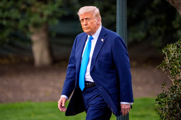 Donald Trump walks across the White House lawn