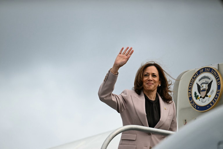 Kamala Harris waves while boarding Air Force Two